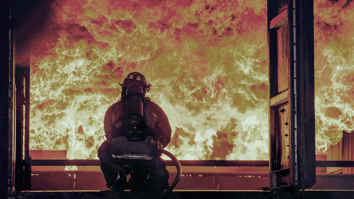 Firefighter extinguishing fire
