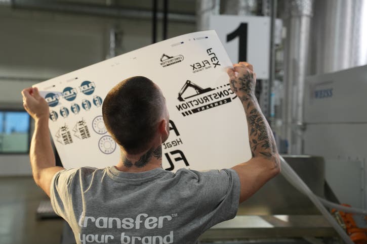 Picture of production staff holding a sheet up to the light